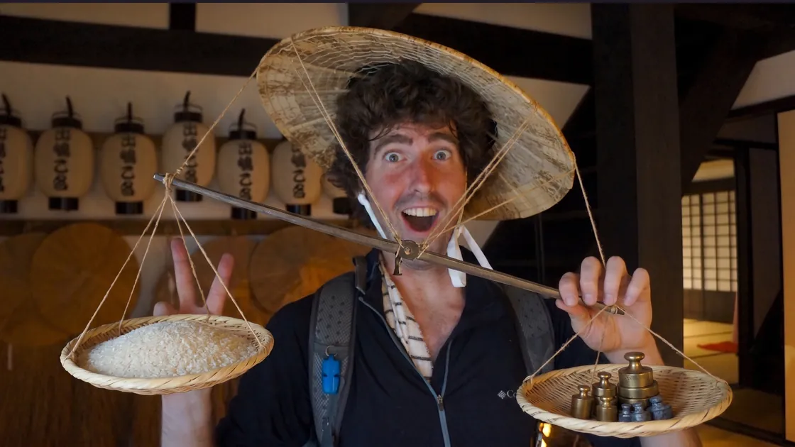 An AI rendition of Jef holding a traditional balance scale, a
                  mound of rice on one pan and brass weights on the other.