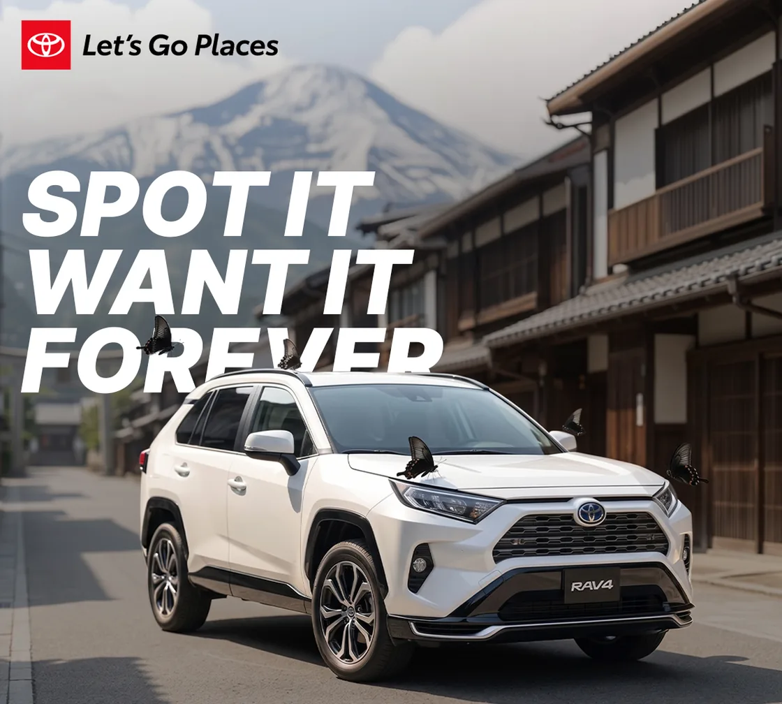 A mock Toyota advert: a white RAV4 parked on a Japanese street below a
                snow-capped mountain, black swallowtail butterflies settled across its
                bonnet and roof. The headline reads SPOT IT, WANT IT, FOREVER.